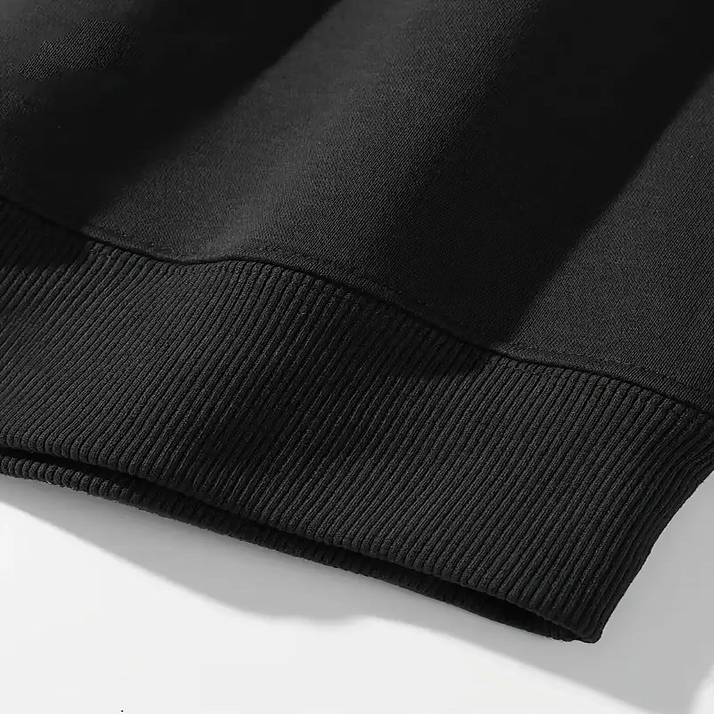 Close-up of the ribbed cuff and hem on the black London After Dark Graphic Crewneck Sweatshirt