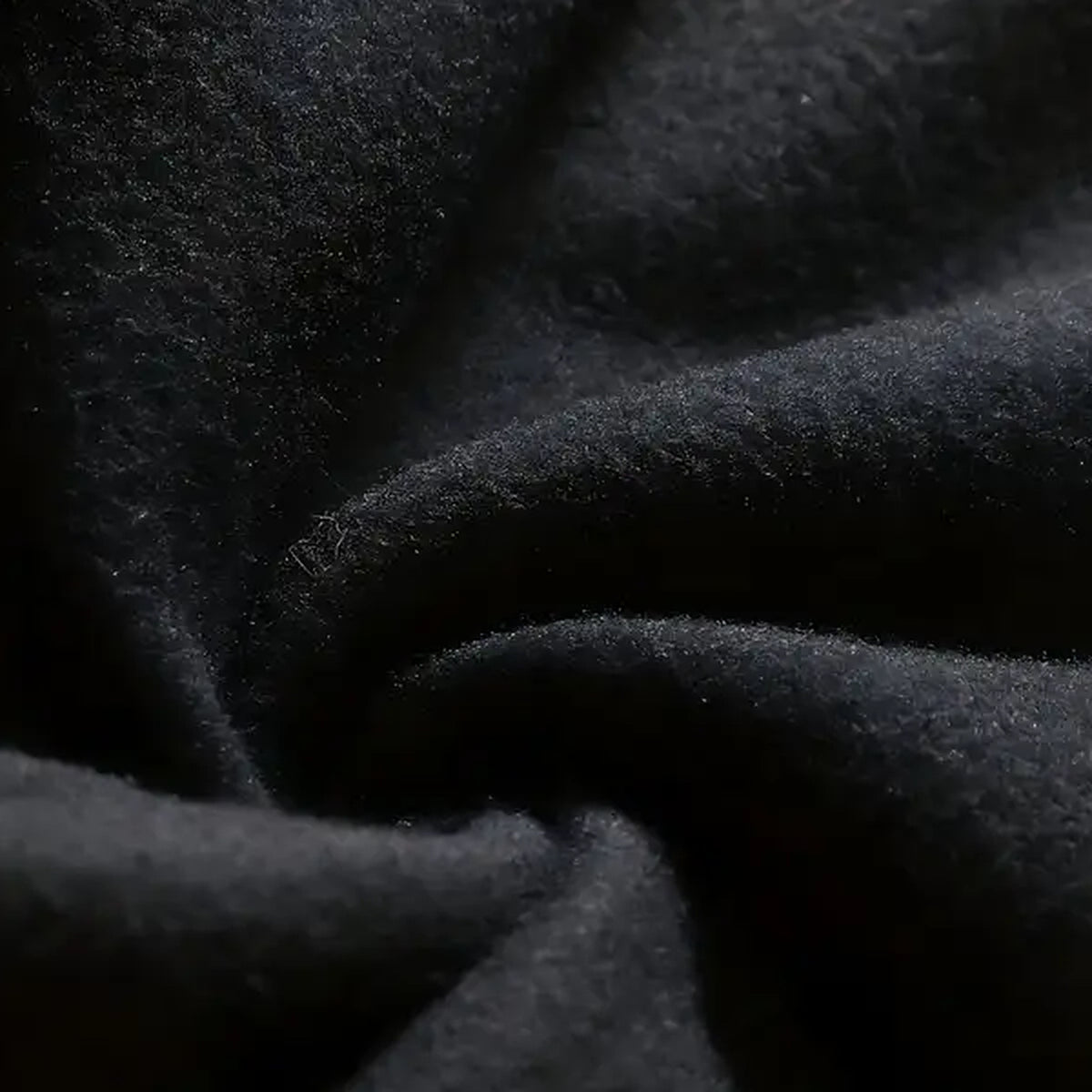 Close-up of the black Light In The Dark Graphic Hoodie fabric texture