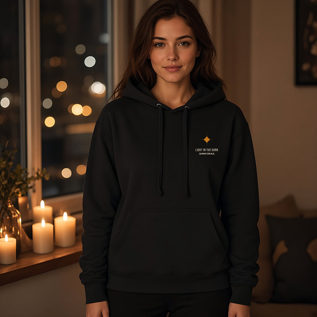 Model wearing the Light In The Dark hoodie in black, front view
