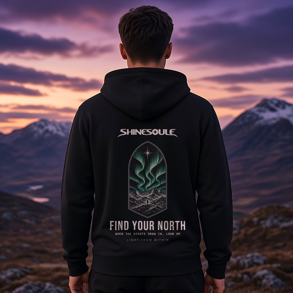 Model wearing the Northern Light hoodie in black, back view showing the FIND YOUR NORTH print