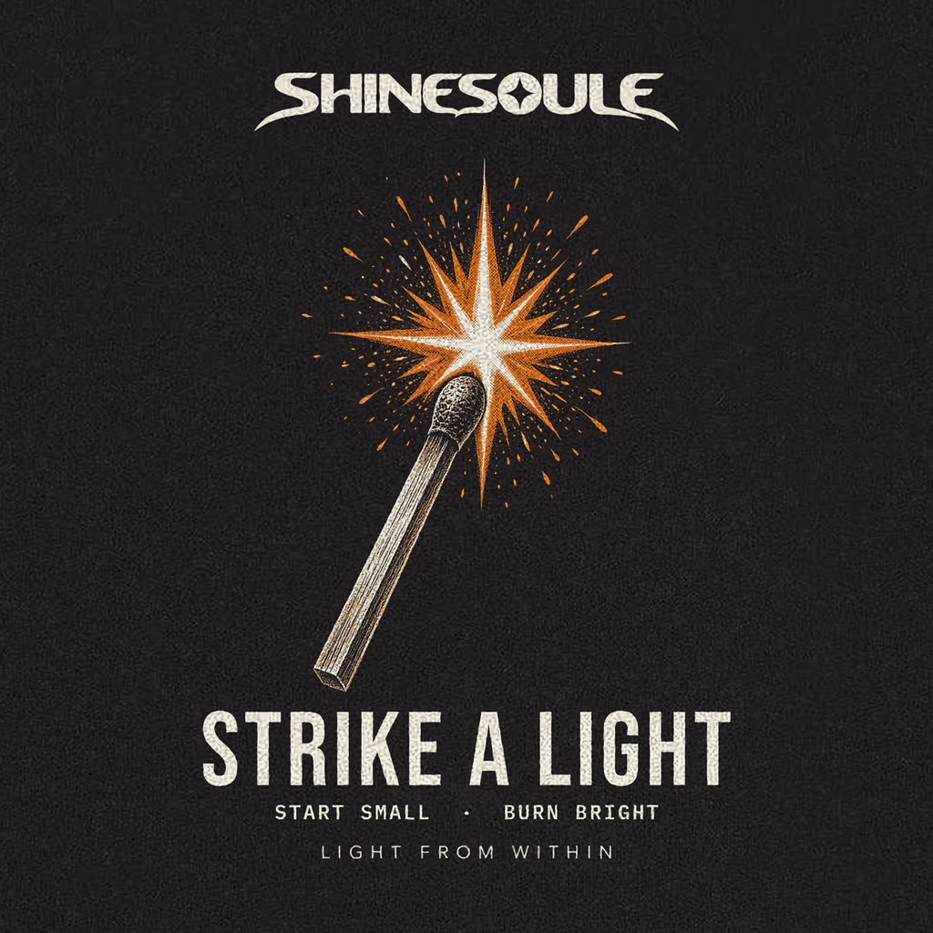 Close-up of the STRIKE A LIGHT print: a match bursting into an orange spark